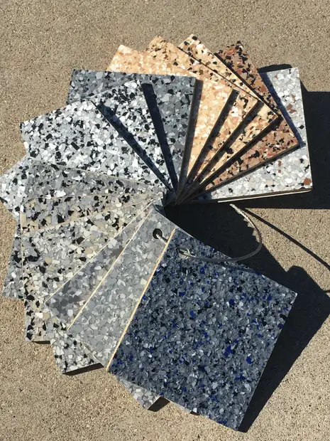 A fan of flake chip sample boards in gray, blue, black and tan blends