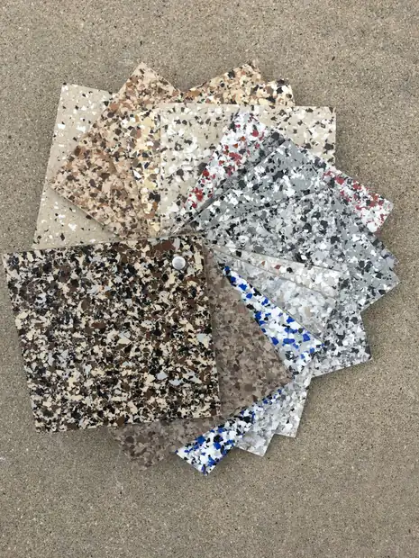 Flake sample boards fanned open showing tan, black, blue and red fleck blends