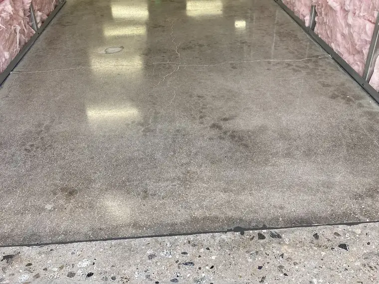 Bare concrete floor ground clean in a room lined with insulation
