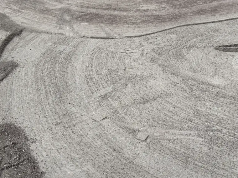 Swirl pattern left in a concrete slab by the grinder after coating removal