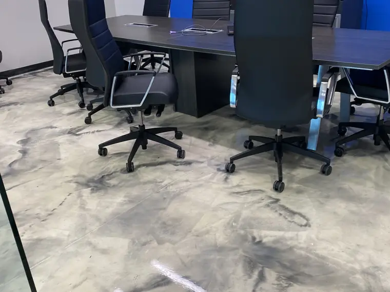 Conference room with a marbled metallic epoxy floor and a blue accent wall