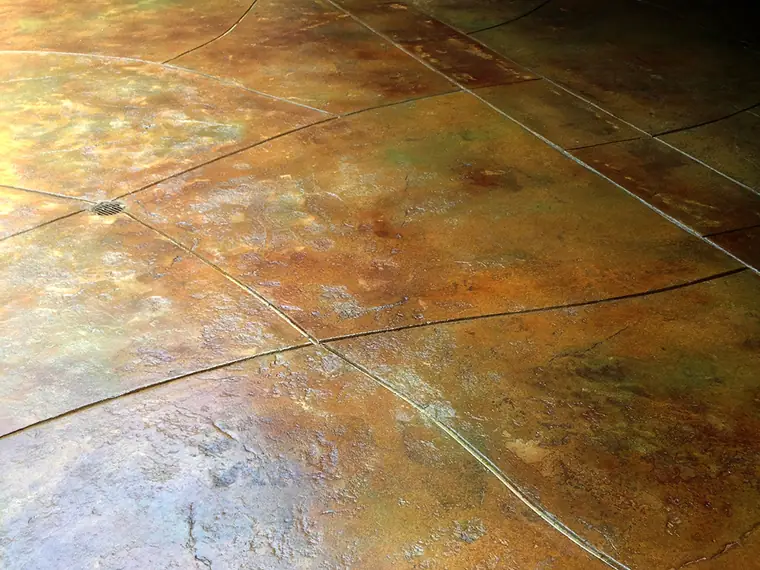 Mottled orange and green acid-stained patio surface