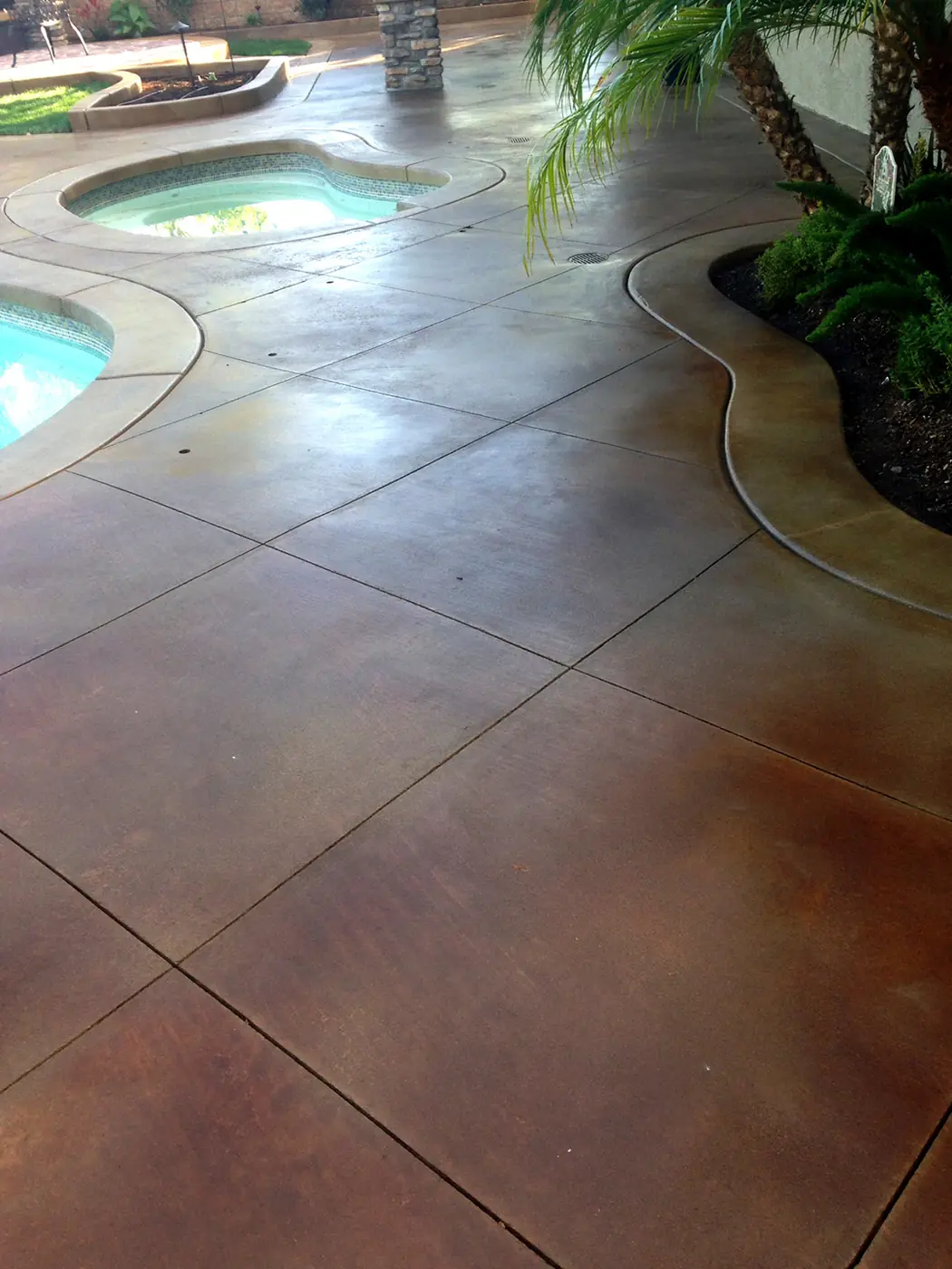 Pool and spa deck stained and scored into large tiles