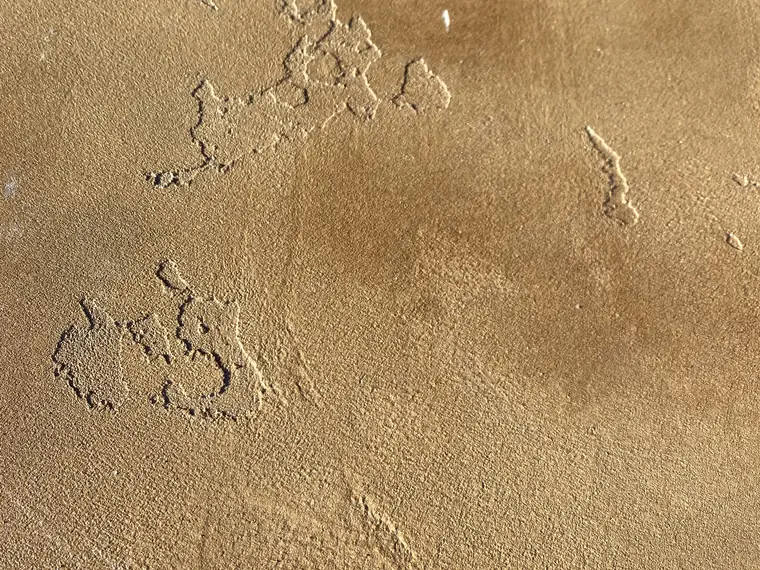 Close view of a trowel-textured tan microtopping surface