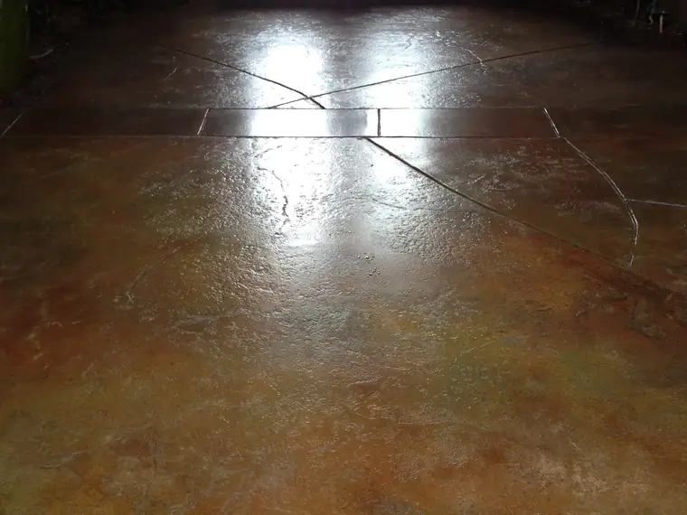 Mottled tan stained entry floor with score lines and double doors