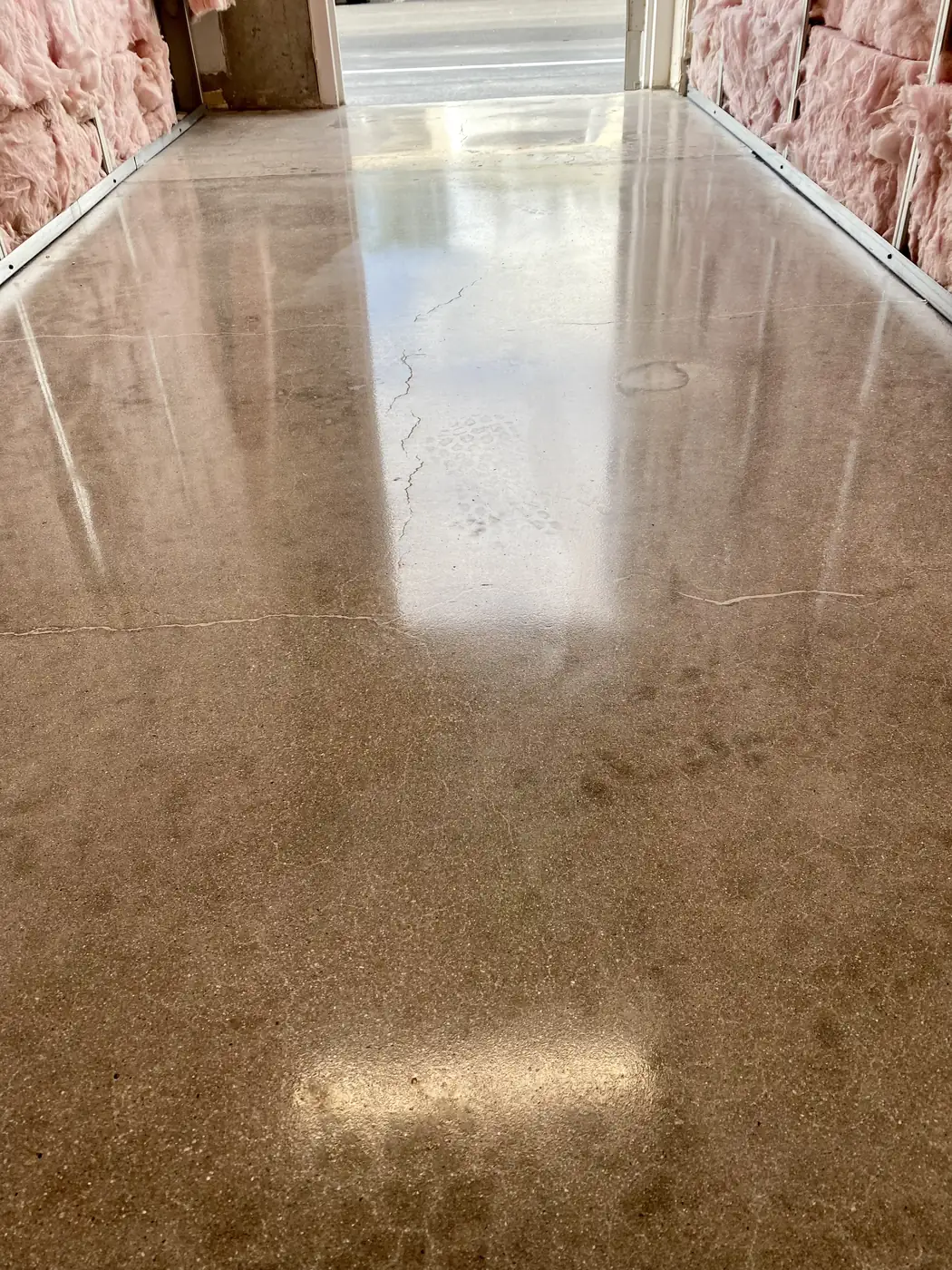 Polished concrete floor in warm gray with light reflections