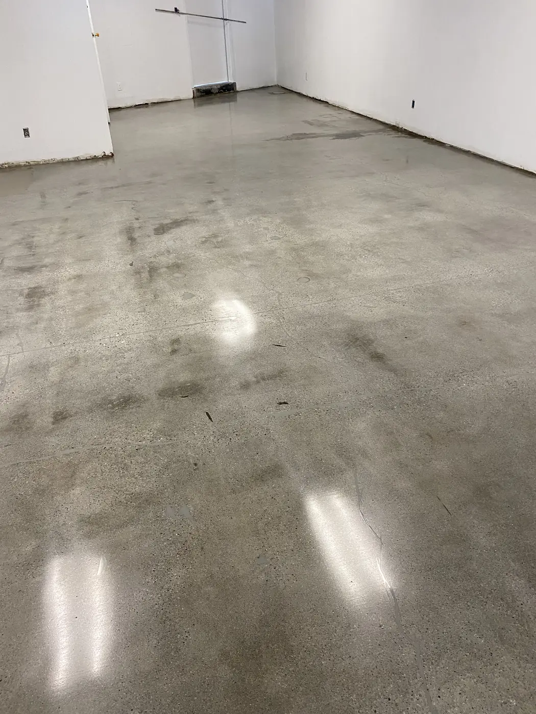 Mottled gray polished concrete floor in an empty commercial space