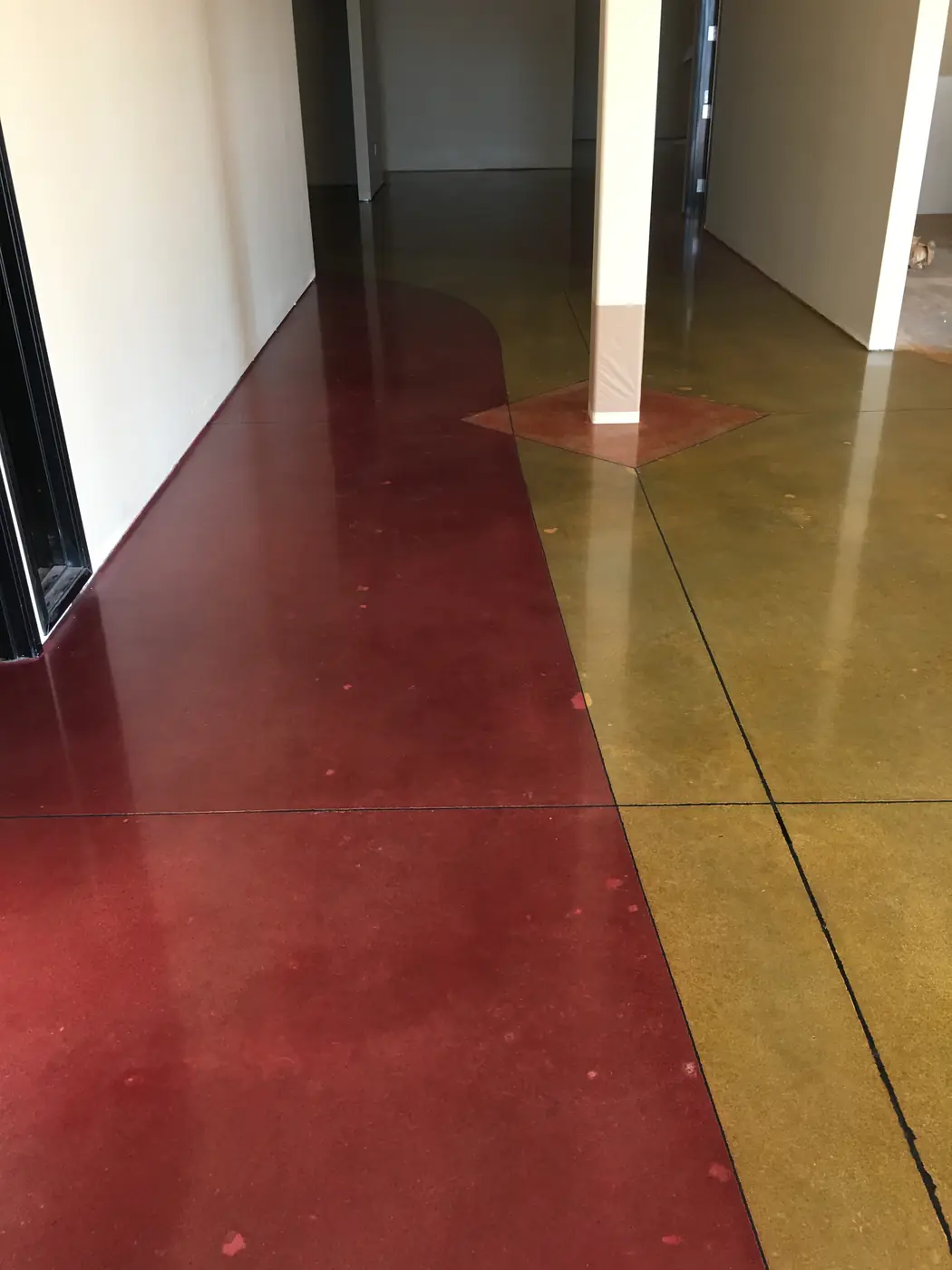 Red and gold stained polished floor beside white columns