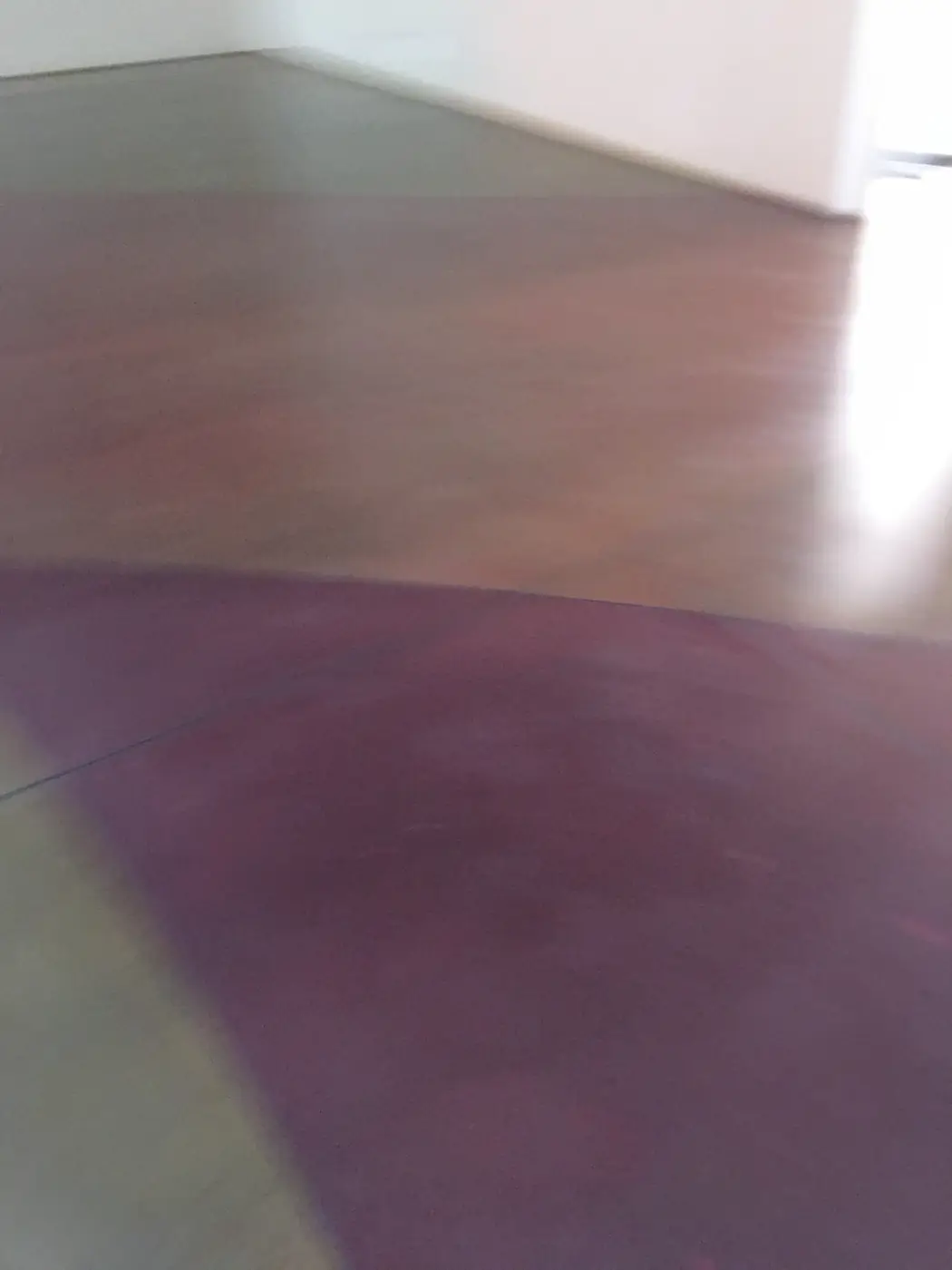 Close view of purple and orange staining blended into polished concrete