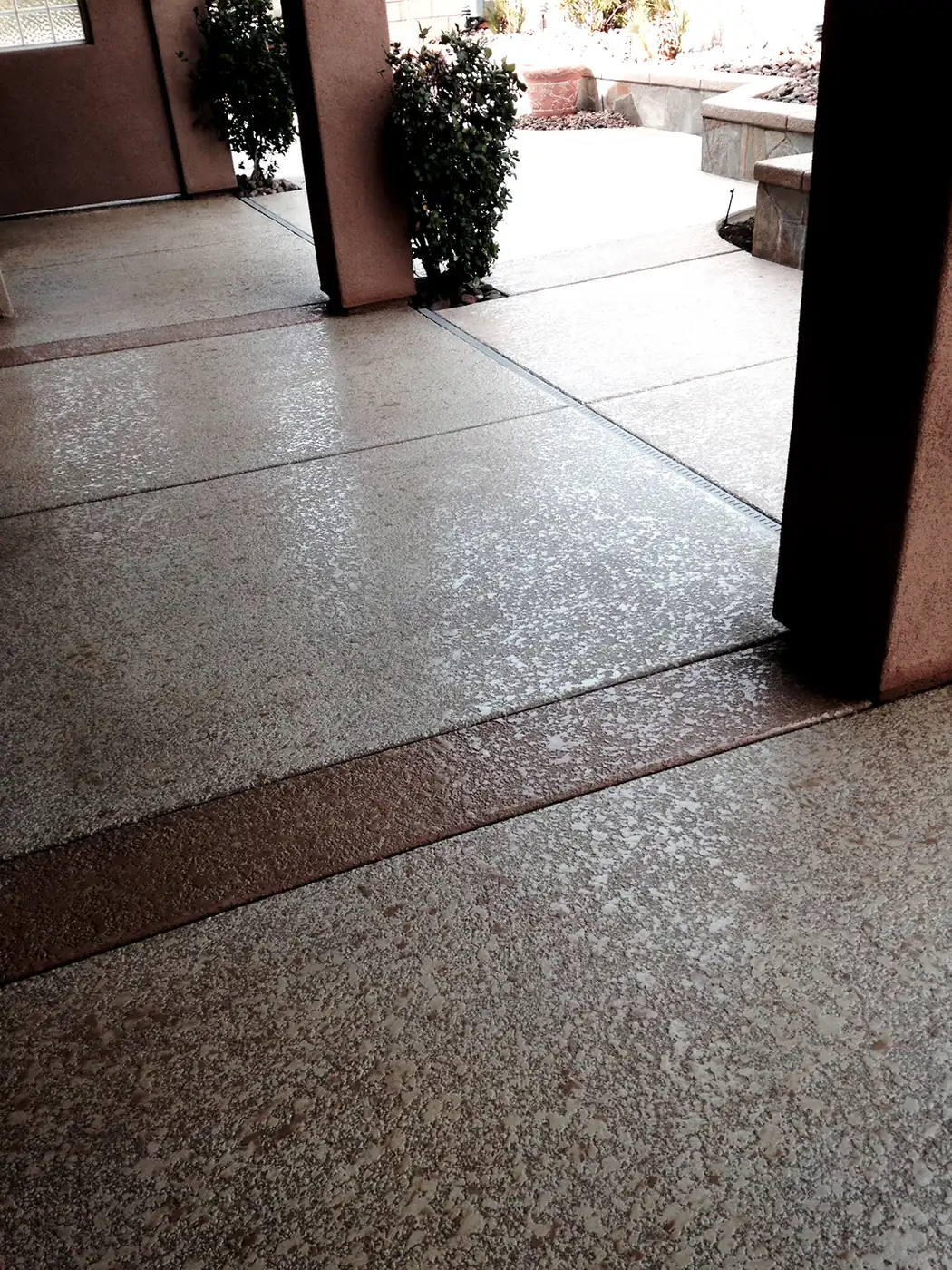 Gray flake textured deck under a covered patio