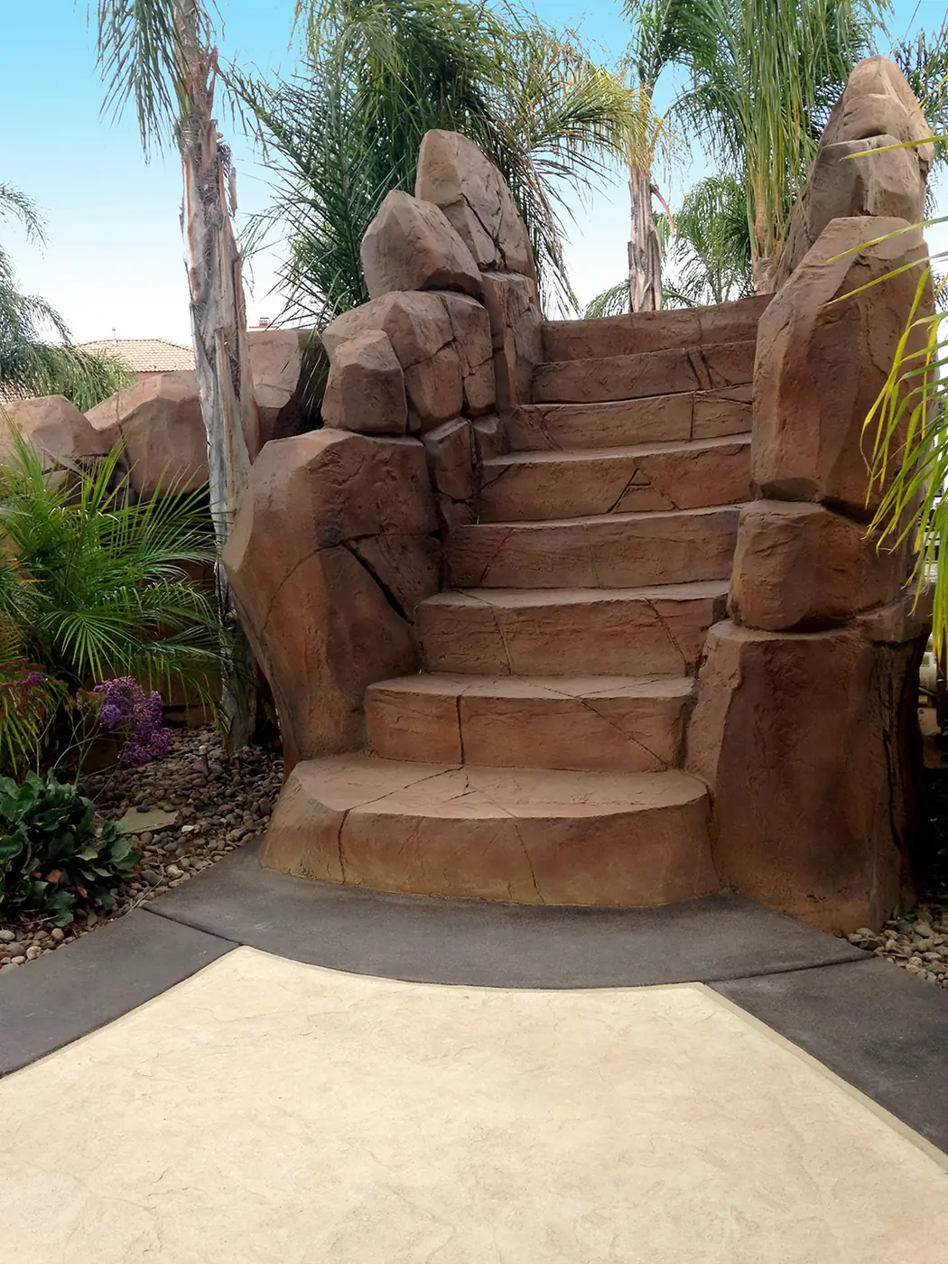 Restained boulder staircase climbing between planted beds